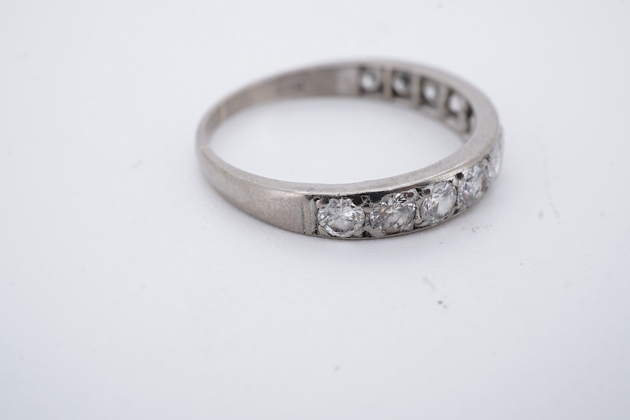 A diamond half eternity ring, set to the front with a sequence of brilliant-cut diamonds totalling approximately 0.80 carats, mounted in white gold, size O1/2, stamped 18CT, gross weight approximately 2.5 grams